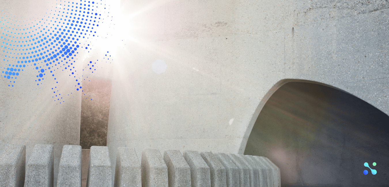 Abstract stone structure with sunlight flare, symbolizing the emergence and evolution of blockchain from obscurity to a transformative technology.
