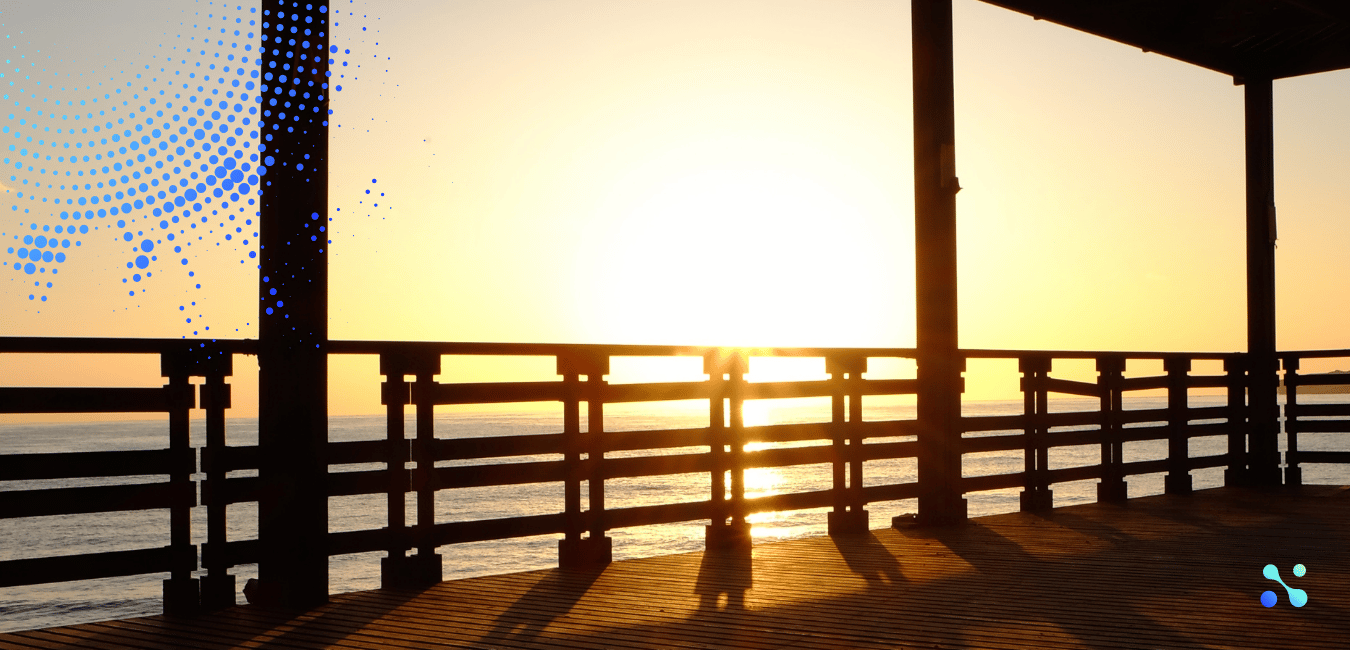 Sunset over the ocean viewed from a wooden pier, symbolizing transition and new horizons.