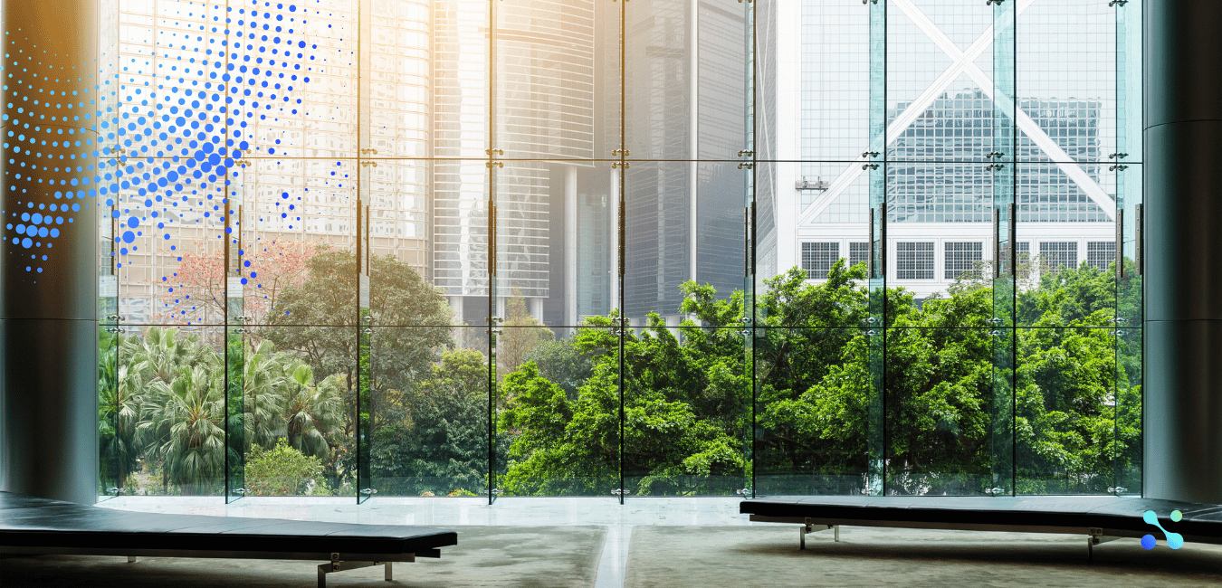 Modern glass-walled building with greenery outside, symbolizing transparency and growth in fintech and blockchain.